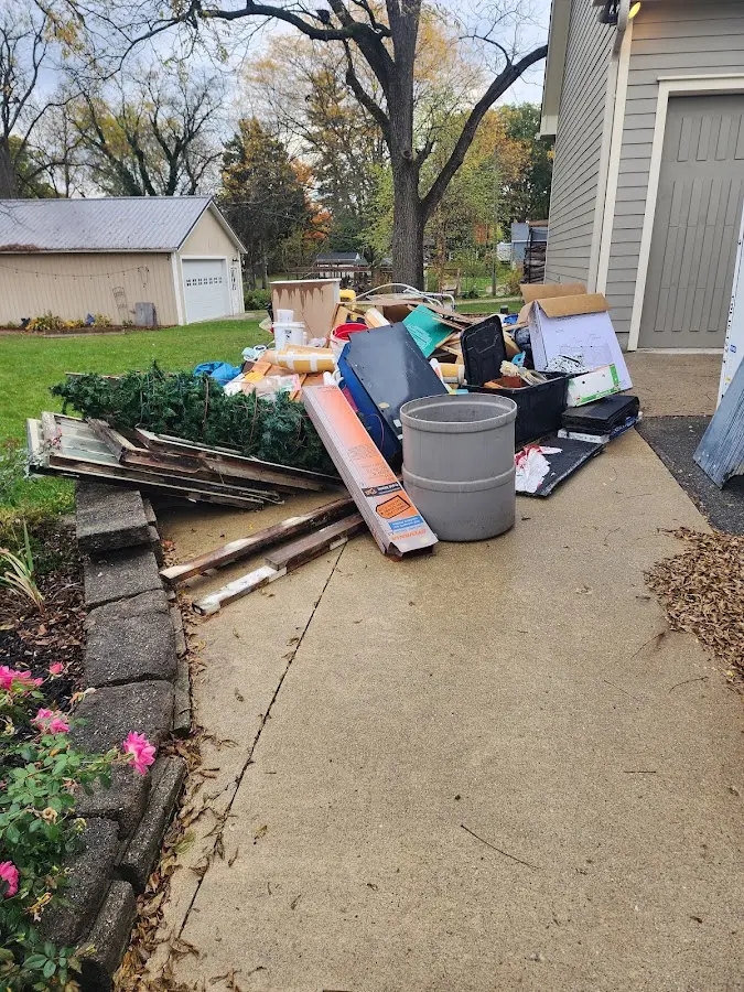 Dumpster being loaded with debris for Estate Cleanout Dumpster Rental in Dracut